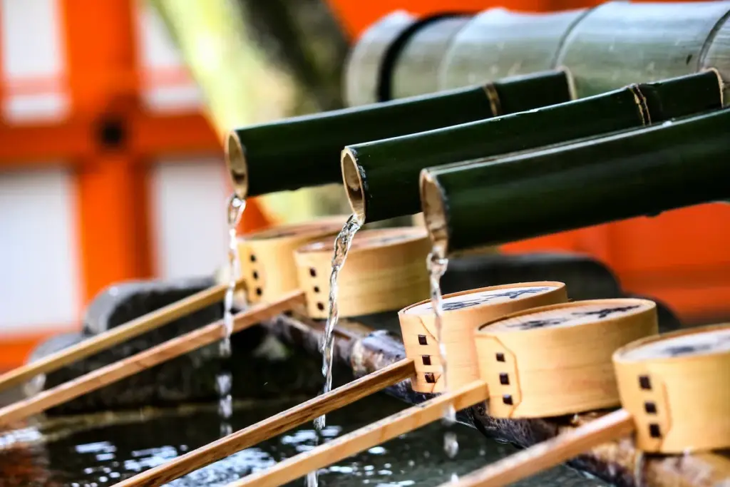 Wooden ladles and bamboo fountain at a temizuya (water purification pavilion) in a Shinto shrine. Used for washing hands and mouth before praying.