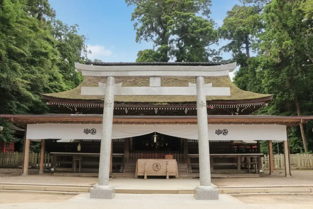 Main worship hall (haiden) of Kashima Jingu Shrine with granite torii and cedar forest in Ibaraki