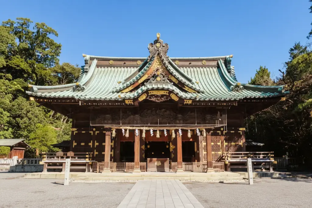 Worship hall (haiden) of Mishima Taisha with its curved copper roof and detailed wooden carvings